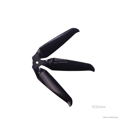 Close-up of assembled 3-blade prop showing blade shape and center mounting hole