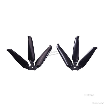 Two assembled 3-blade props shown side by side, hub center holes visible