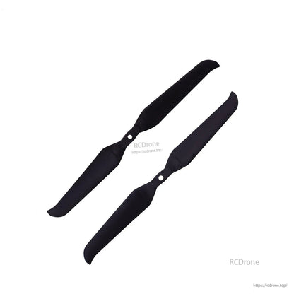 Two propellers shown diagonally, black two-blade design with mounting holes at the hub