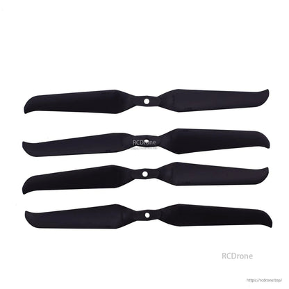 Four assembled-looking two-blade propellers laid horizontally, black finish with center mounting holes