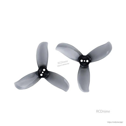 Two smoke gray 3-blade propellers with three-hole hubs, left and right orientations