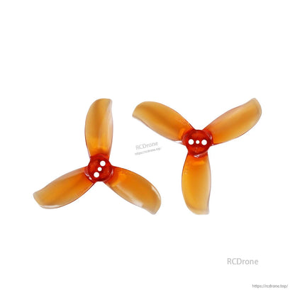 Pair of amber 3-blade propellers with three-hole hubs, two orientations