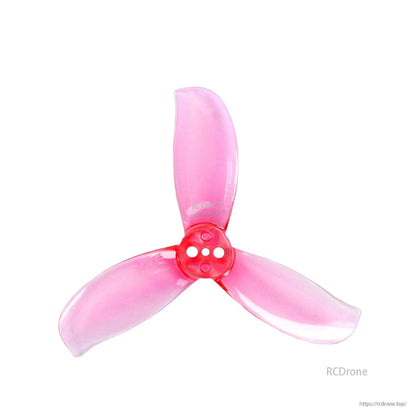 Single translucent pink 3-blade FPV propeller with red hub, top view