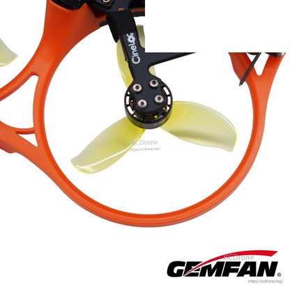 Translucent yellow 3-blade prop installed in orange duct on cinewhoop frame, close-up