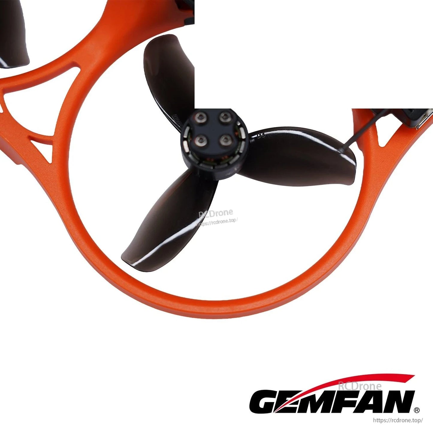 Black 3-blade prop installed inside an orange duct, close-up showing mounted hub and blade clearance