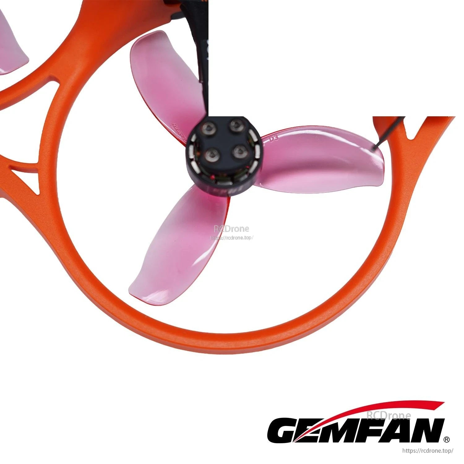 Transparent pink 3-blade prop installed inside an orange duct, close-up of motor hub mount