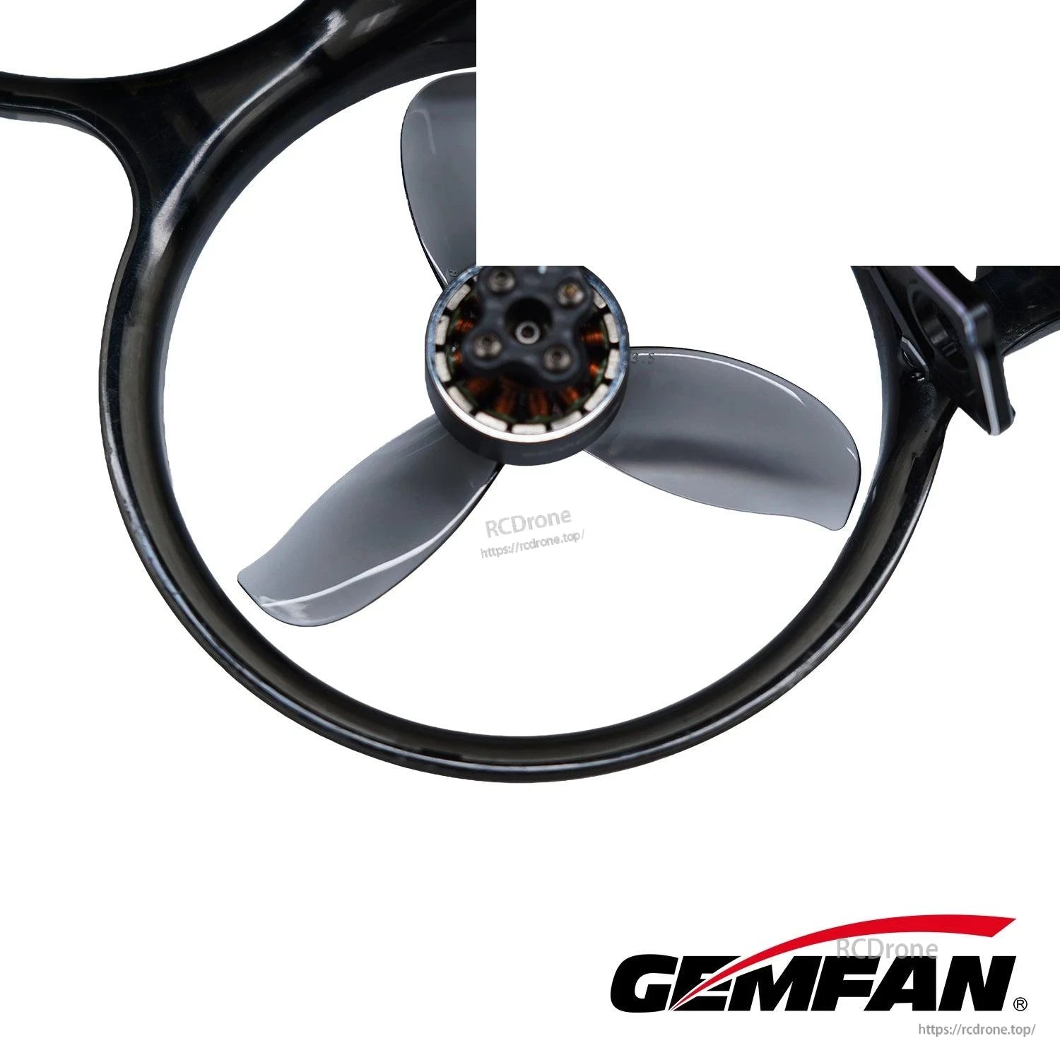 Close-up of dark gray tri-blade propeller mounted in a ducted ring around the motor