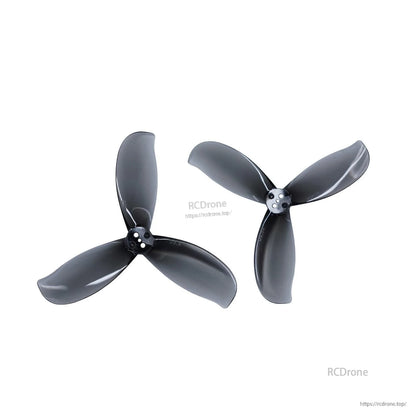 Two dark gray tri-blade propellers shown as a pair, different orientations on white background