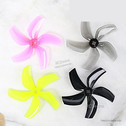 Gemfan D76-5 propeller set colors shown together: pink, smoke gray, neon yellow, and black