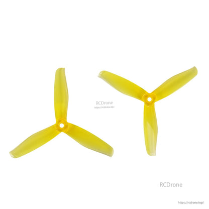 Yellow three-blade propeller pair, top view showing blade shape and center hub