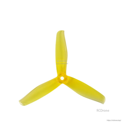Single yellow three-blade drone propeller, top view with center mounting hole