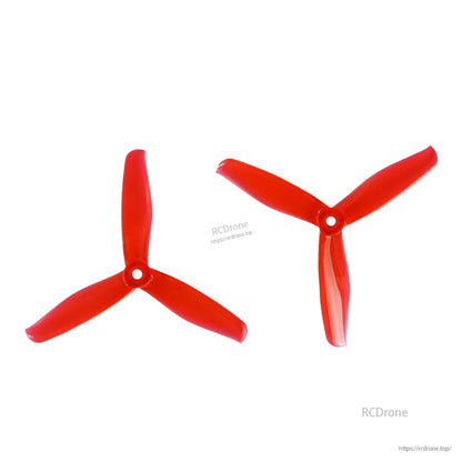 Red three-blade propeller pair, top view showing blade profile and center hub
