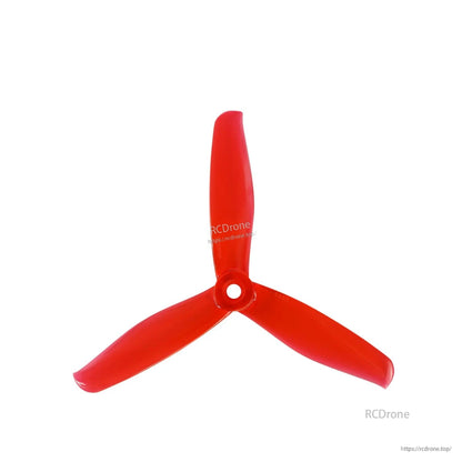 Single red three-blade drone propeller, top view with center mounting hole
