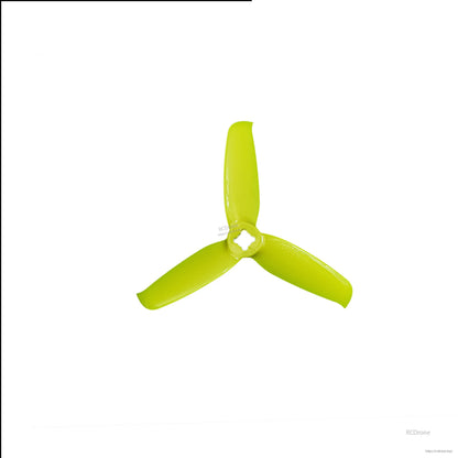 Yellow 3-blade drone propeller, close-up top view