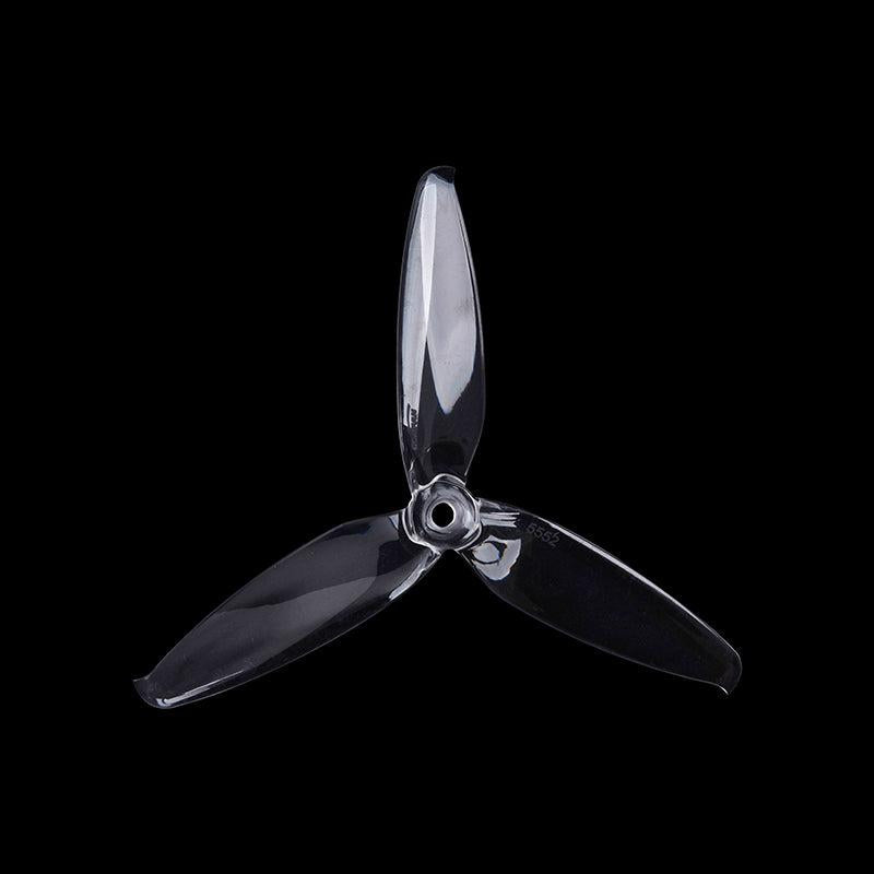 Smoke gray transparent 3-blade propeller on black background, top view showing blade profile