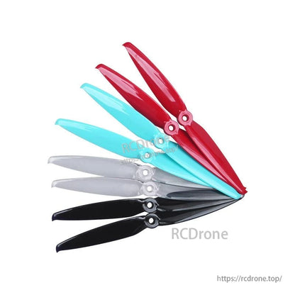 Gemfan Flash 7042-2 PC propellers shown in multiple colors stacked together: red, turquoise, clear, black