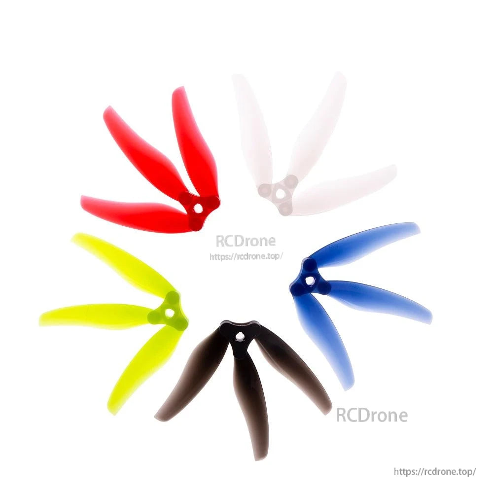 Assorted folding 3-blade propellers arranged in a circle: red, clear, blue, black, and neon yellow