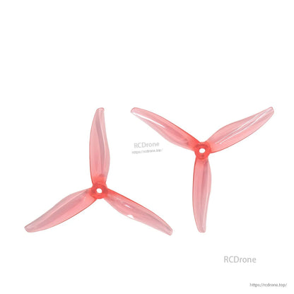 Pair of translucent red tri-blade propellers displayed on white background