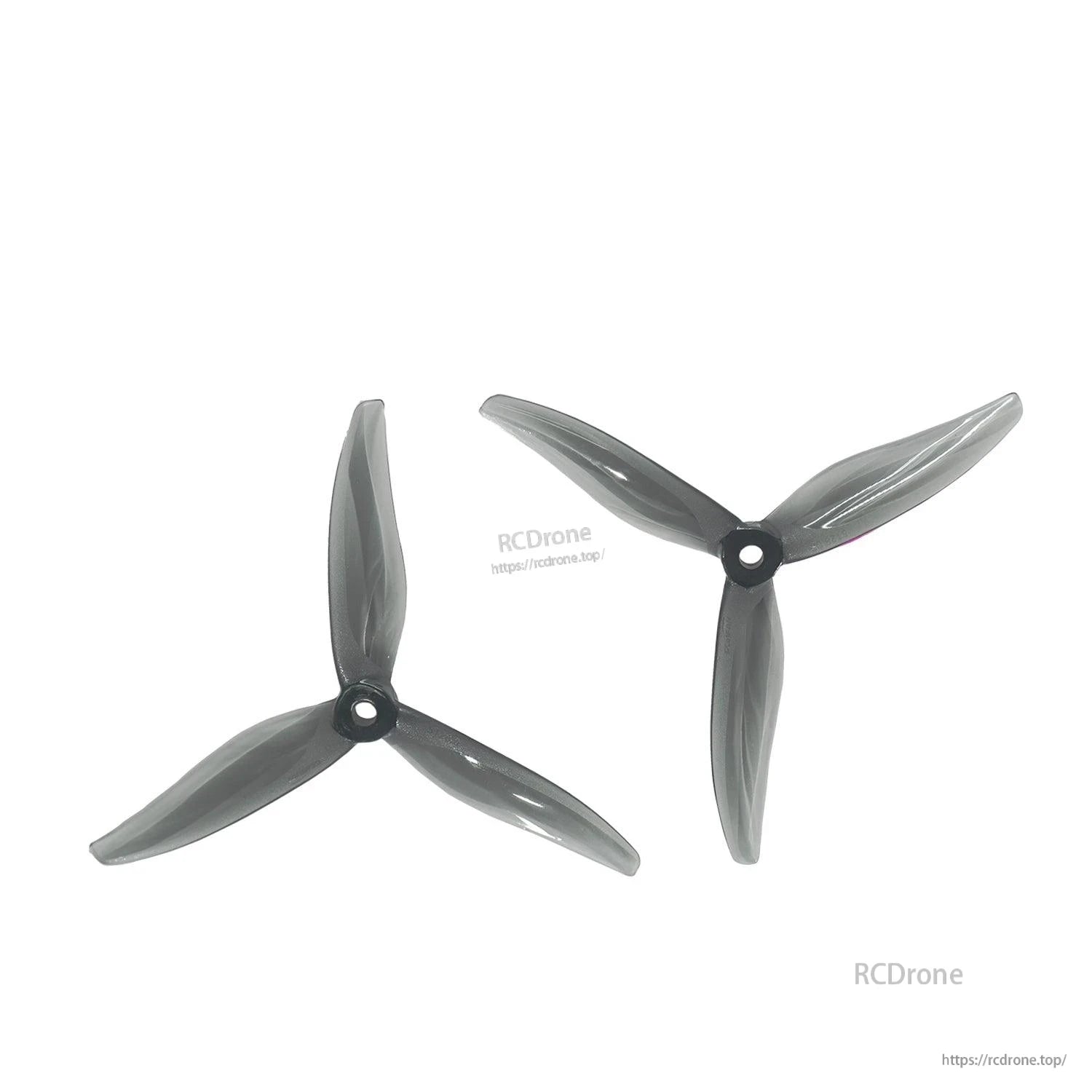 Pair of smoke black tri-blade propellers displayed on white background