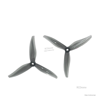 Pair of smoke black tri-blade propellers displayed on white background