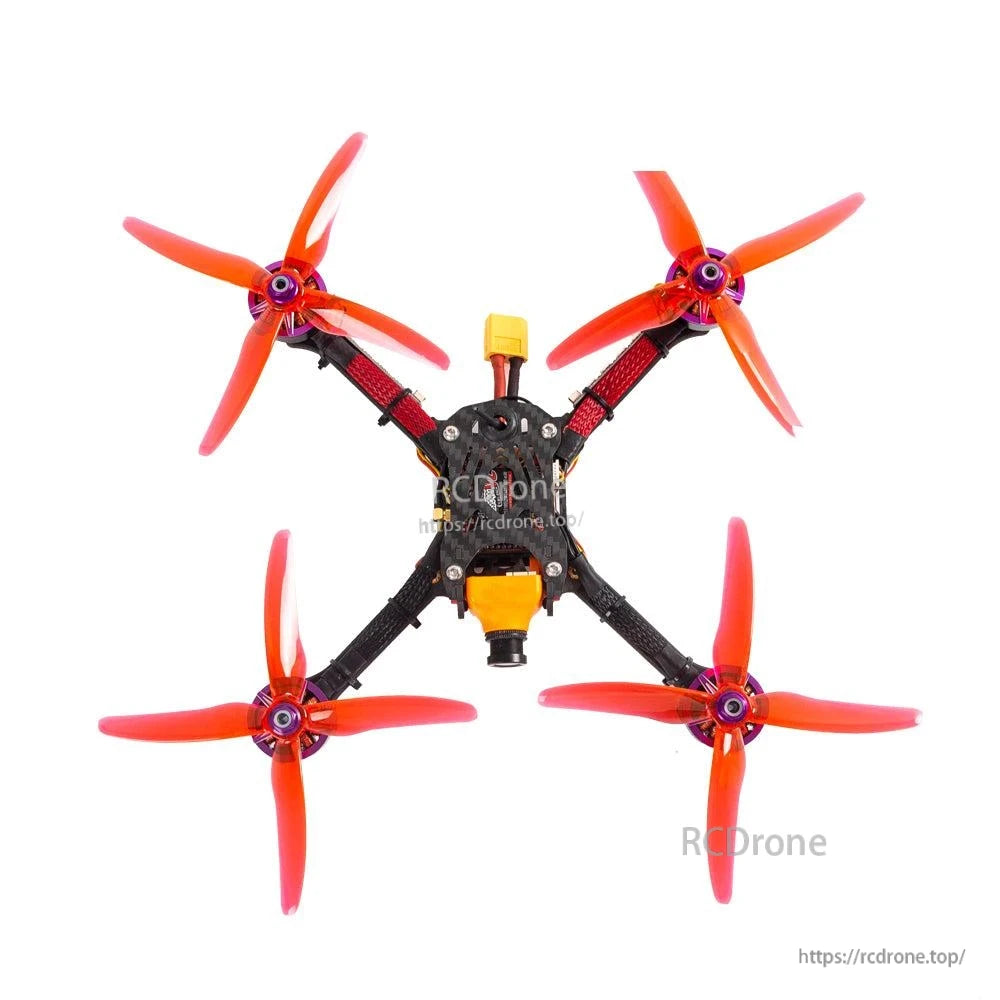 Four red 4-blade propellers installed on an FPV quadcopter frame, top-down view
