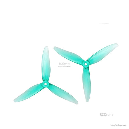 Two translucent teal 6x4.5 tri-blade propellers with center mounting hole, left and right rotation views