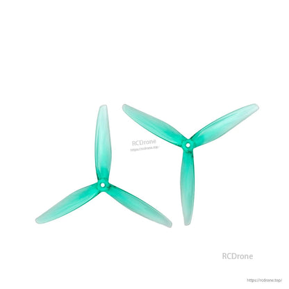 Pair of clear green tri-blade propellers shown side-by-side at different orientations