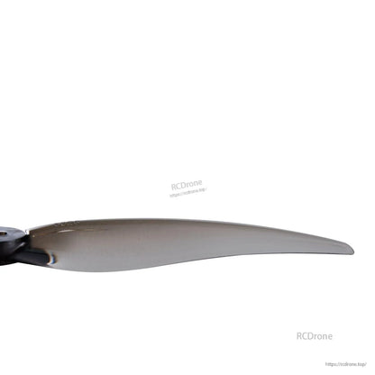 Close-up of smoke gray propeller blade section showing thickness and edge profile