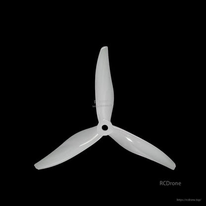 White 3-blade propeller on black background, top view of hub and blade sweep