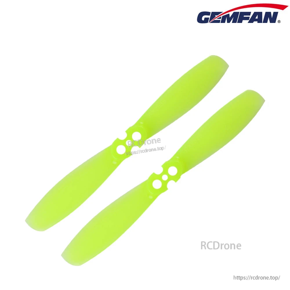 Pair of neon green two-blade propellers with 2-hole mounting hub, angled view