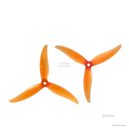 Translucent orange 3-blade propellers pair, two angles showing blade sweep and hub