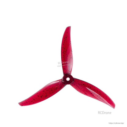 Single red 3-blade propeller with black speckles, top view showing hub opening