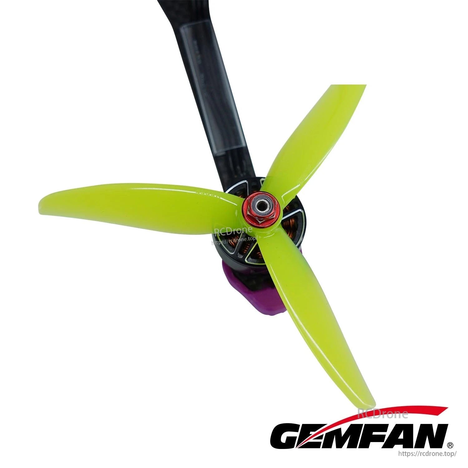 Neon yellow 3-blade FPV propeller mounted on motor, close-up of hub and blades