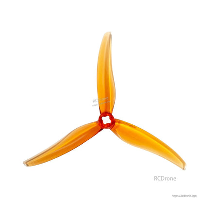 Amber/orange translucent 3-blade propeller, top view with red hub detail