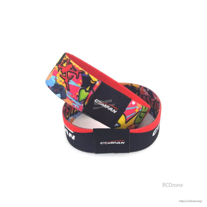Two Gemfan stack saver straps stacked, showing sewn logo patch and loop construction details
