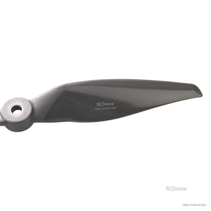 Close-up of propeller blade profile near the tip, showing curved airfoil shape