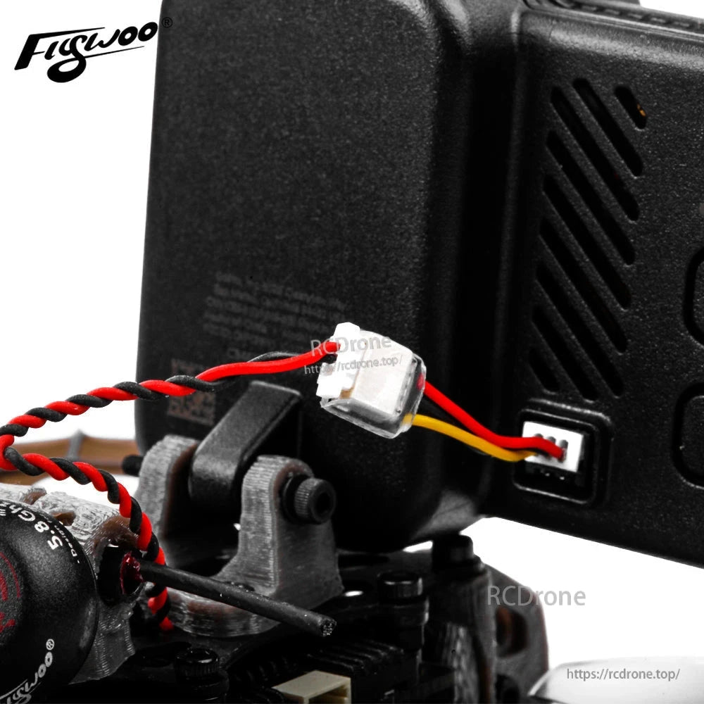 GoPro 10 Bones adapter cable with small white plug and red/black twisted wire connected to the camera port
