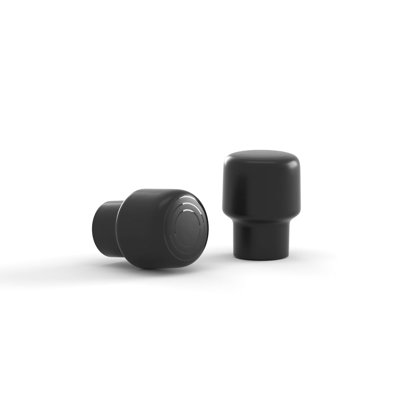 Two black stub antennas on white background, one standing and one lying on its side