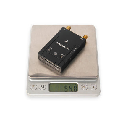 Holybro H-RTK Mosaic-H Dual-Antenna RTK GPS, Mosaic-H RTK GPS on scale, displaying 54.0 grams weight.