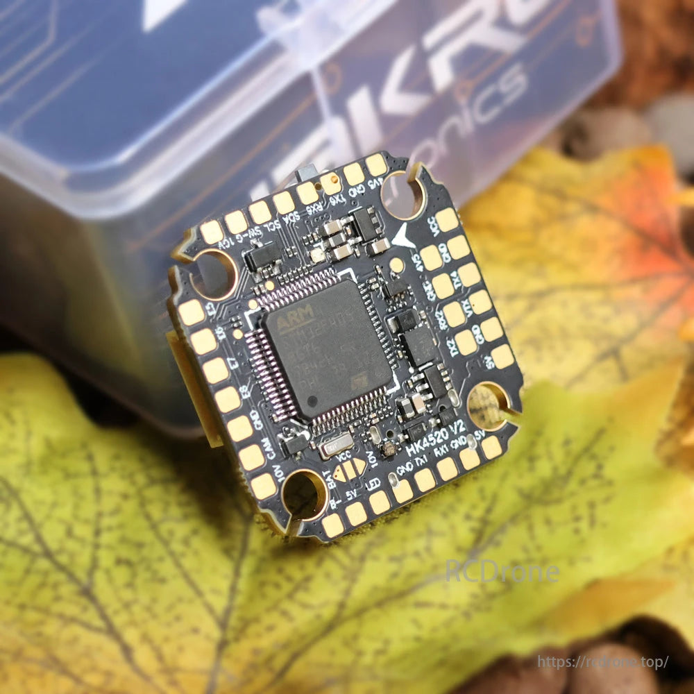 HAKRC F4520 V2 Flight Controller features an ARM chip and labeled pins for easy identification and use.
