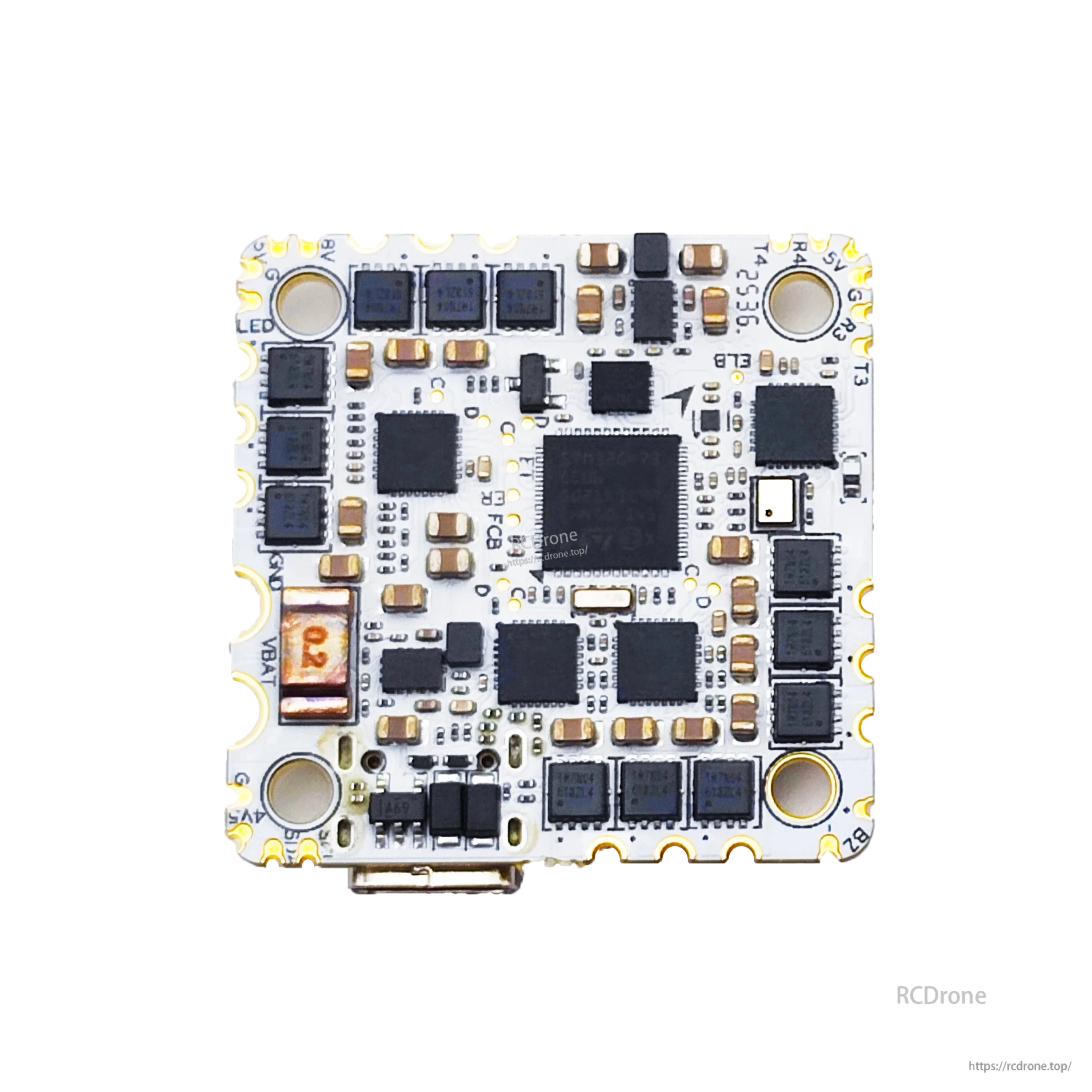 Close-up underside of AIO flight controller board showing MOSFET rows, processor, and edge pads
