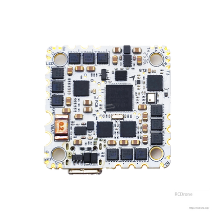 Close-up underside of AIO flight controller board showing MOSFET rows, processor, and edge pads