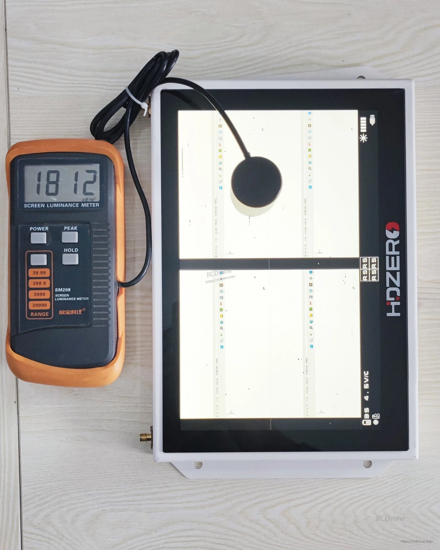 Screen luminance test setup showing HDZero monitor with light meter reading 1812 on display