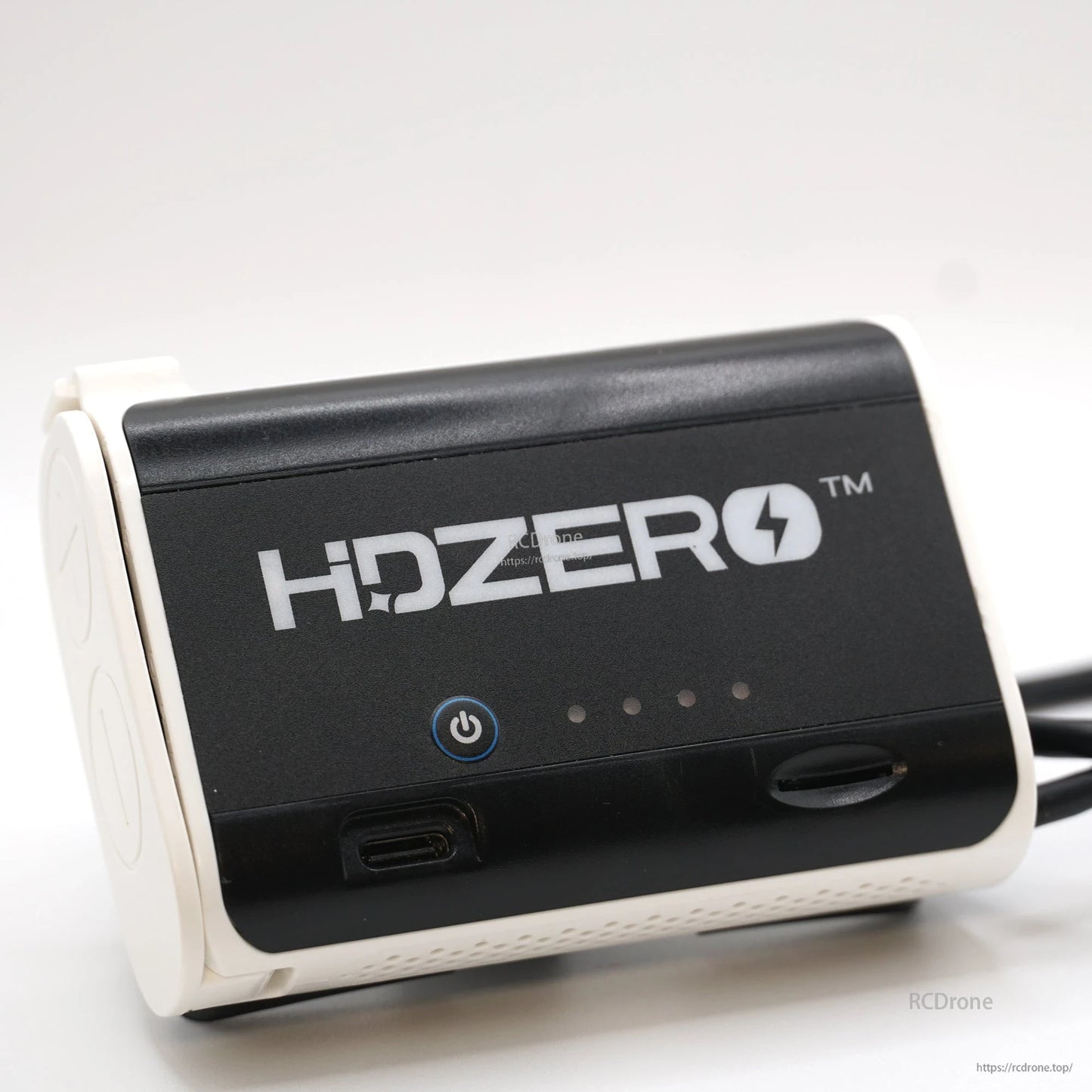 Angled close-up of HDZero battery case front panel with power button, USB-C port, and LED indicators