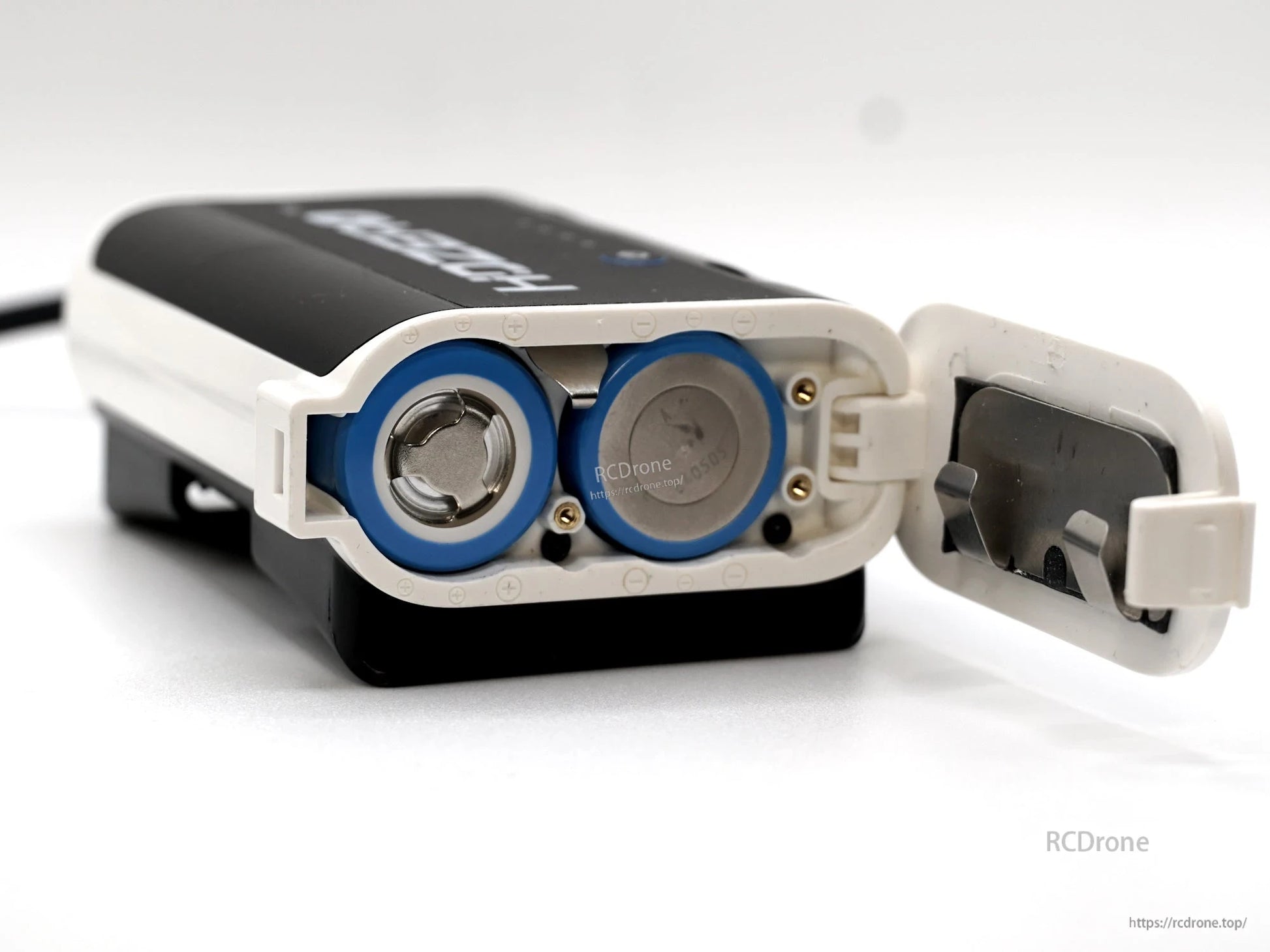Battery compartment open showing two cylindrical cell bays and hinged door on the HDZero case