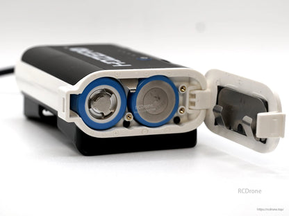 Battery compartment open showing two cylindrical cell bays and hinged door on the HDZero case