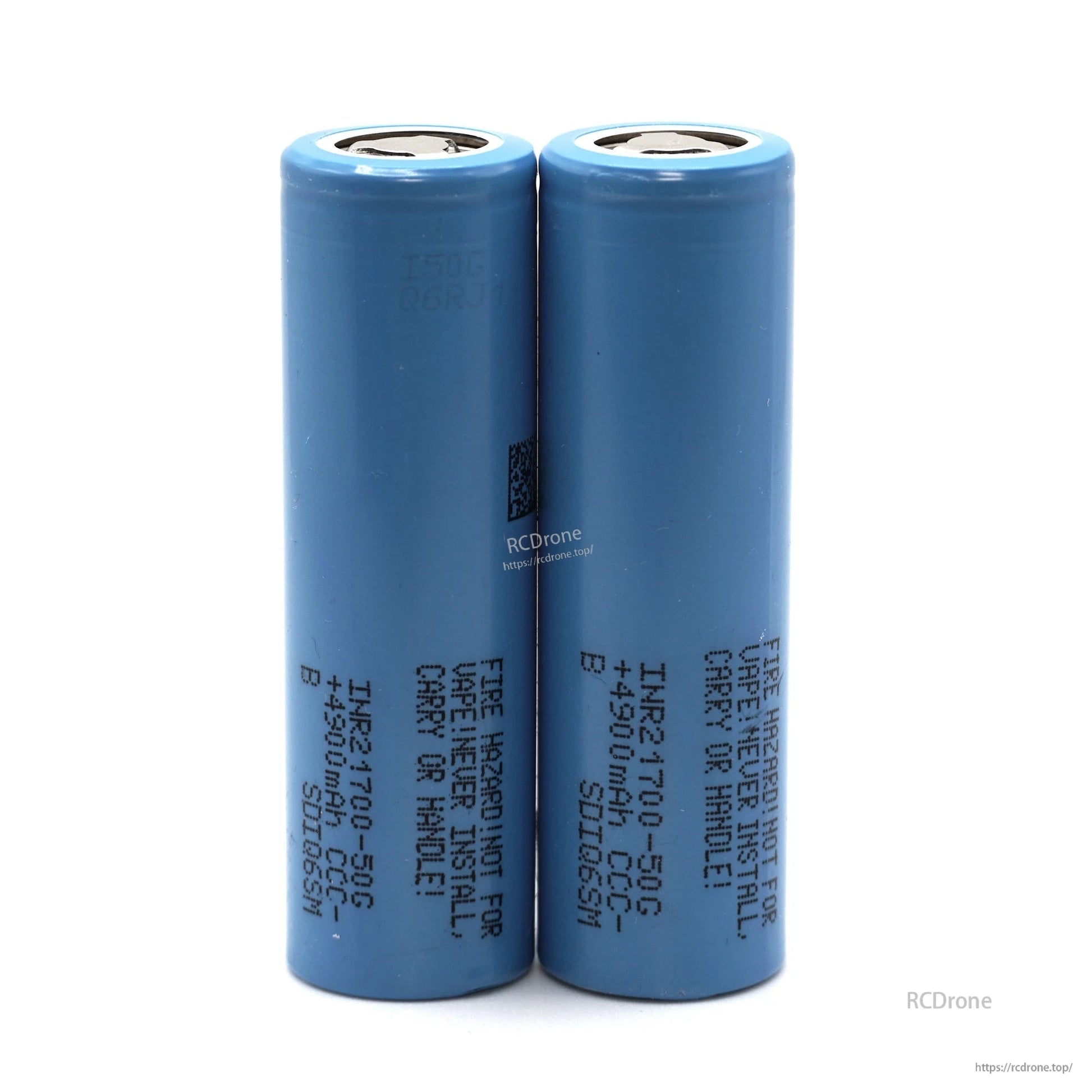 Two blue cylindrical battery cells shown side by side, as used in the rear-mount battery case