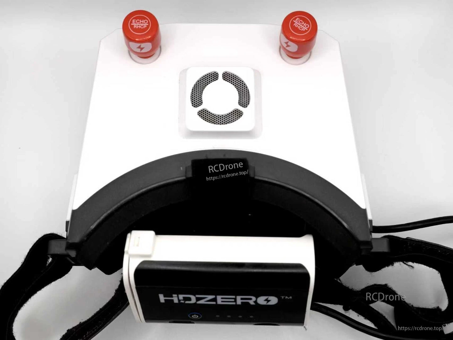 Rear view of white FPV goggles showing HDZero battery case mounted beneath the head strap