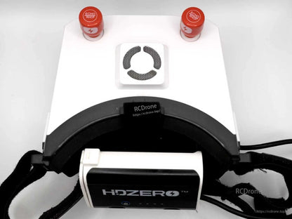 Rear view of white FPV goggles showing HDZero battery case mounted beneath the head strap