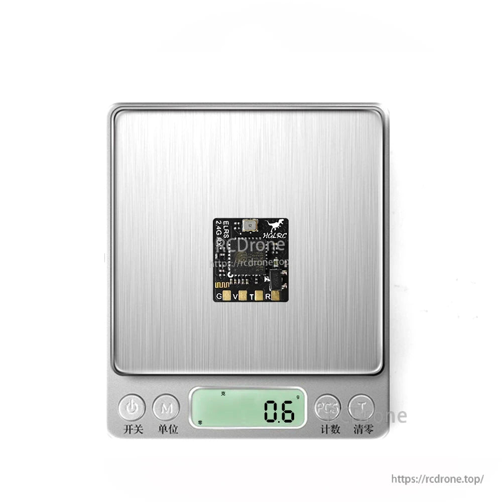 Receiver PCB on digital scale showing 0.6 weight reading